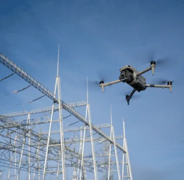Drone in flight beside a steel structure